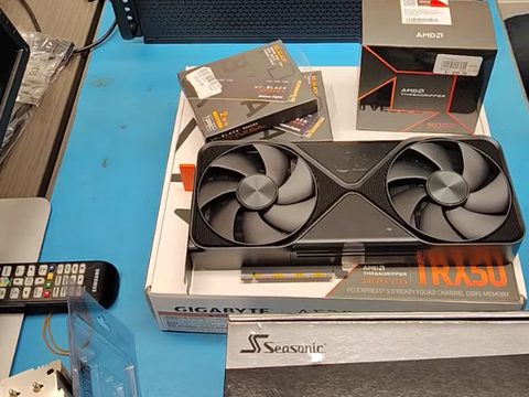 An NVIDIA GPU on the eRacks bench with the parts of a Threadripper build, before assembly